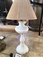 Full view of milk glass table lamp with pleated shade