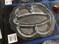 Clear pressed glass divided dish on black surface