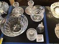 Overall view of bowl, candlesticks, covered jar, bell