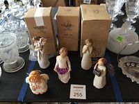 Overview showing five Willow Tree figurines, one small cherub, and three Willow Tree boxes