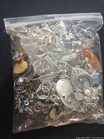 Bag filled with assorted costume jewelry