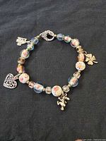Bracelet laid flat showing beads, charms and toggle clasp