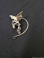 Front view of sterling silver dragon ear cuff