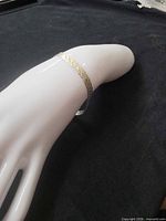 Bracelet displayed on white mannequin hand showing overall appearance and fit
