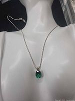 Full view of necklace on bust showing chain length and pendant