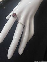 Both rings on display hand showing design and gemstone