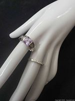 Both rings displayed on hand form