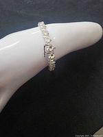 Full bracelet on display form showing clasp and stones