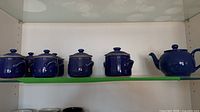 Full set on shelf: six jars and teapot