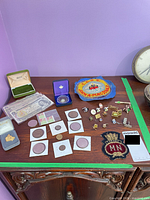 Overall lot view with coins, notes, stamps, pins and patches