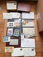 Full layout showing binder, stockbook, small box, loose covers, presentation pages