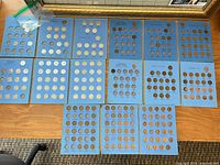 All eighteen blue Whitman coin folders laid out on desk
