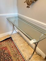 Entire console table showing glass top and metal base