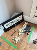 Overall view of coat rack, barometer, magnifying glass, trivet and doorstop