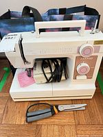 Full view of Janome Model 344 sewing machine with power cord/foot pedal and scissors