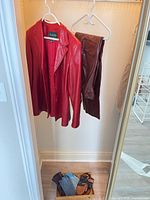 Jacket, pants and gloves grouped in closet