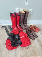 Group of all items: four shoe pairs, jacket, two umbrellas