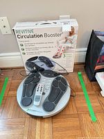 Revitive Circulation Booster with remote on top, box behind