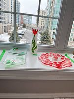 Group shot of vase, four plates, platter and bowl on windowsill