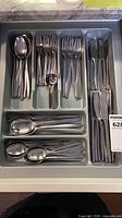 Full drawer view of complete Dansk stainless flatware set in tray