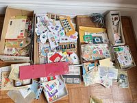 Six boxes containing loose and on-paper postmarked stamps