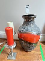 Overall lot showing vase, two candle holders with candles