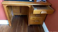 Front view of desk showing top, left kneehole and right drawer stack