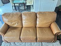 Front view of entire sofa showing three leather seats