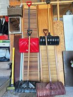 All four snow shovels leaning against wall