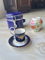 Jar, demitasse cup on saucer, floral vase group shot