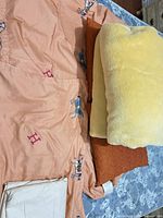 Peach duvet cover, yellow fleece blanket, brown blanket visible