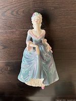 Front view of Regina figurine showing gown and facial details