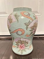 Front view of porcelain vase showing peony and fan motifs