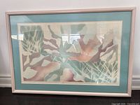 Framed abstract artwork with pastel colors, light teal mat, light pink frame