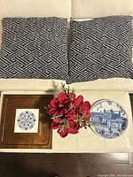 Group shot of plate, pillows, framed tile and floral arrangement