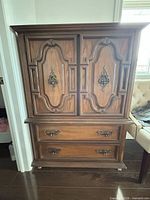 Front view of wooden chest with two cabinet doors and two lower drawers