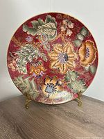 Front view ceramic floral decorative plate on metal stand