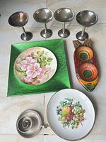 Overview showing five goblets, green plate, floral plate, fruit plate, wooden fish tray
