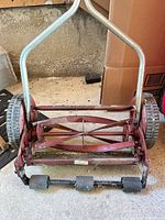 Front view showing full lawn mower, handle, reel, wheels