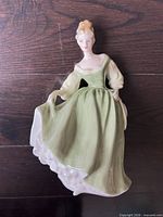 Front view of Fair Lady figurine showing dress and pose