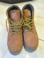 front view of both boots showing uppers, laces, logo