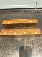 Top view of both incense boxes showing distinct brass inlay patterns