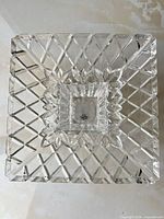 Top view showing both stacked square bowls with diamond pattern and leaf border