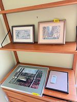Overview of lot showing two framed prints, framed photograph and empty frame