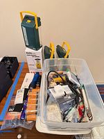 Overview of lanterns, flashlights and assorted batteries in tub