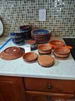 Group shot of all redware dishes on countertop