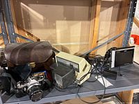Pentax camera, leather case, Argus viewer, color monitor and cables on shelf