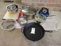 Group shot of all cookware, bowls, kettle, cutting boards