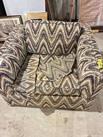 Front view of chevron upholstered armchair with seat cushion removed