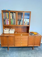 Full view of Drexel shelving unit showing upper hutch with glass doors and lower credenza base
